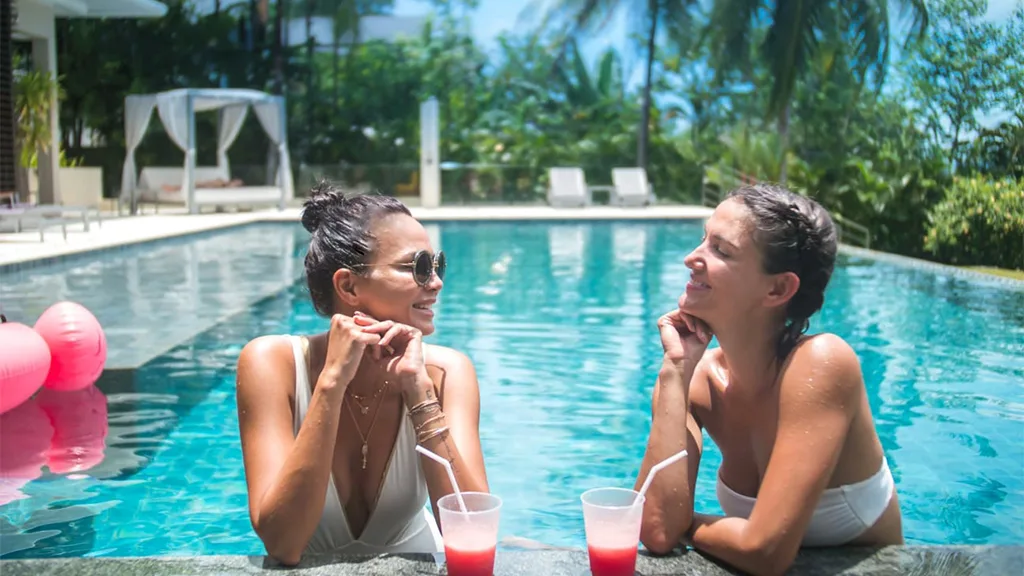 Sonia and Cindy enjoying drinks by the pool