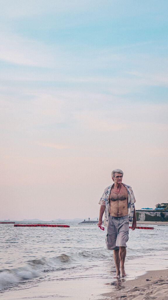 Holidays with seniors by the beach at sunrise.