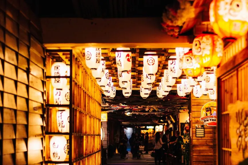 Traditional Japanese lanterns hanging above a covered walkway