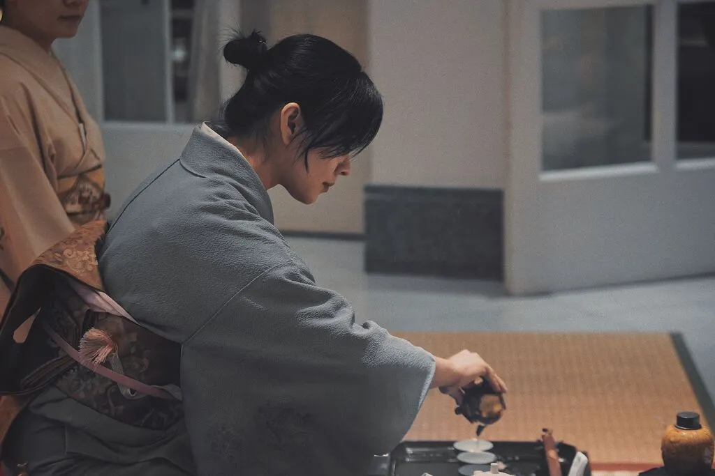 Traditional Japanese tea ceremony with a woman in a kimono