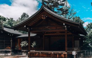 Traditional Japanese wooden temple surrounded by trees