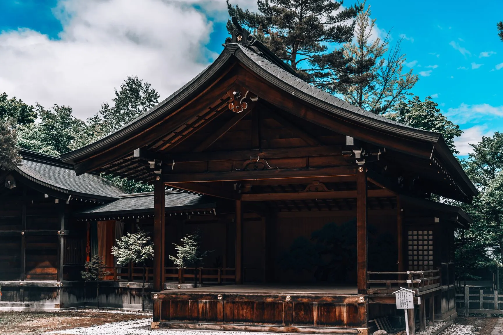 Traditional Japanese wooden temple surrounded by trees