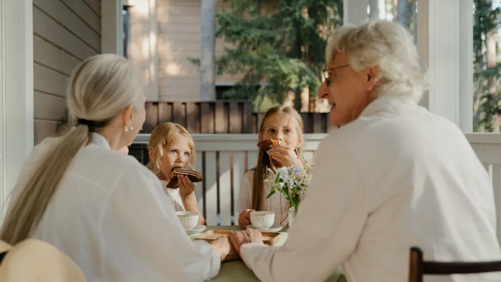 Grandparents spending time with grandchildren at the patio of villa